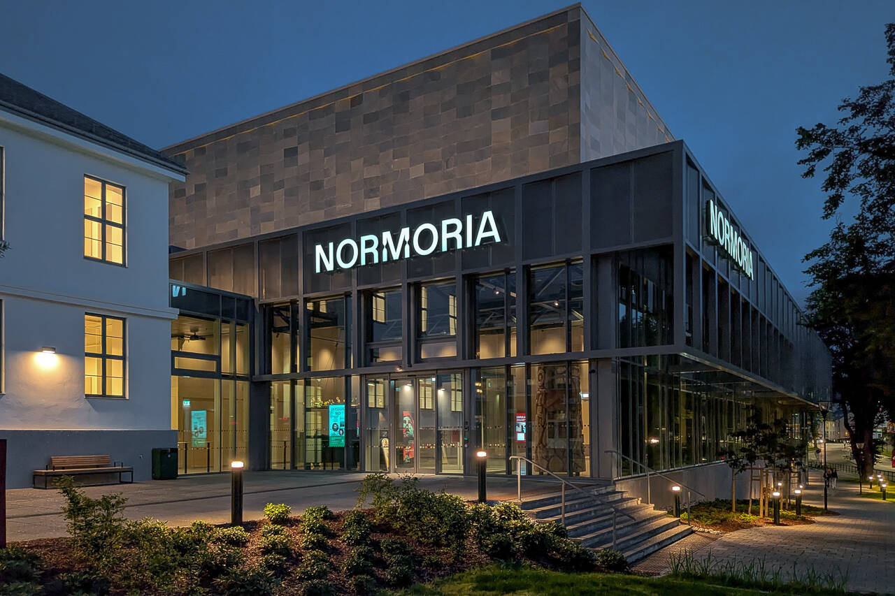 Hovedinngangen med Normoria-skiltet, fotografert i blåtimen.